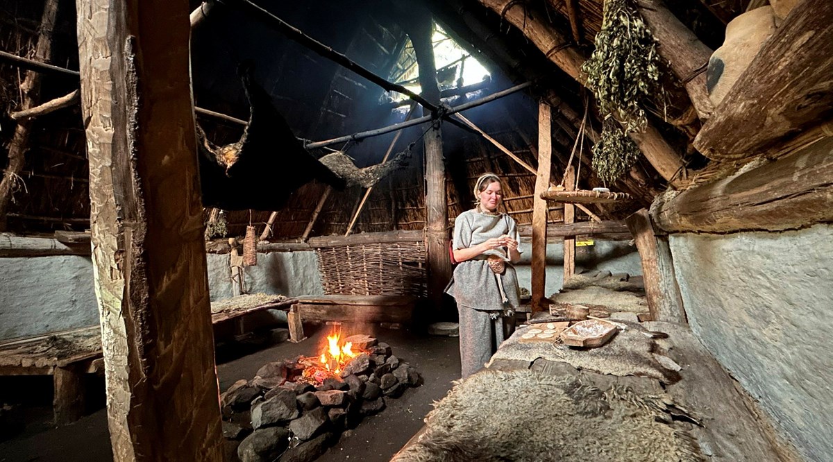 a woman baking bread in the lounghouse.