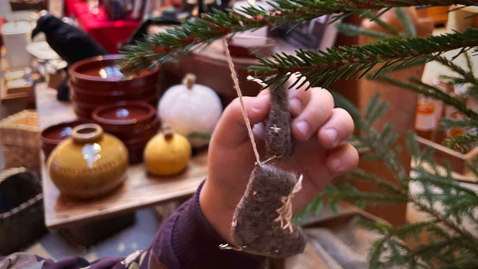 a hand is holding christmas decorations
