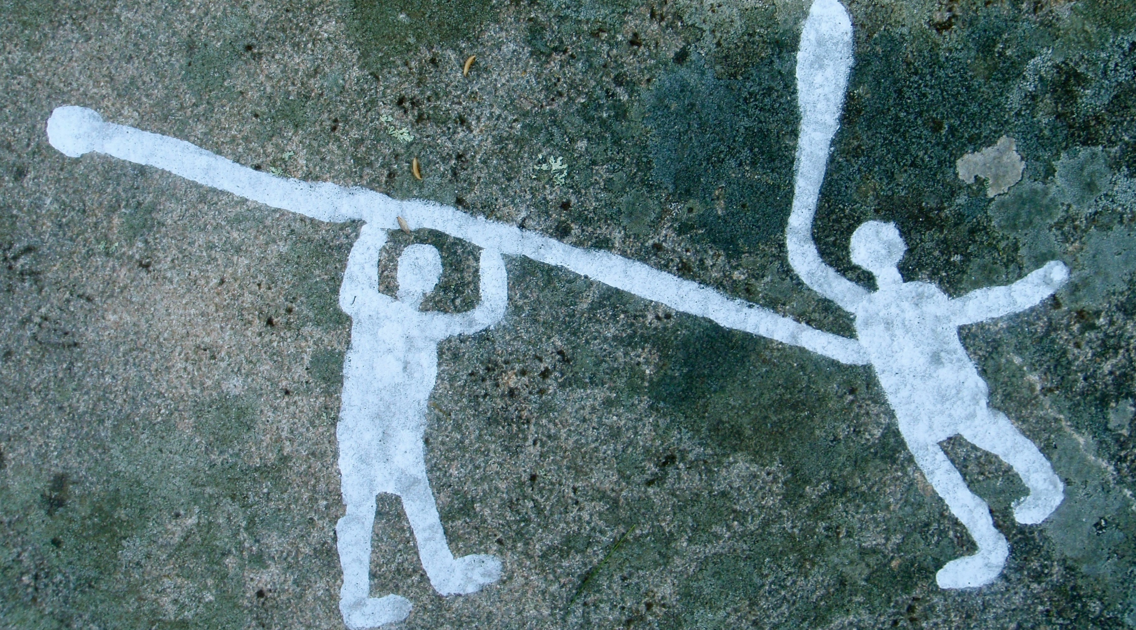Rock carving show two persons with spear and sword.